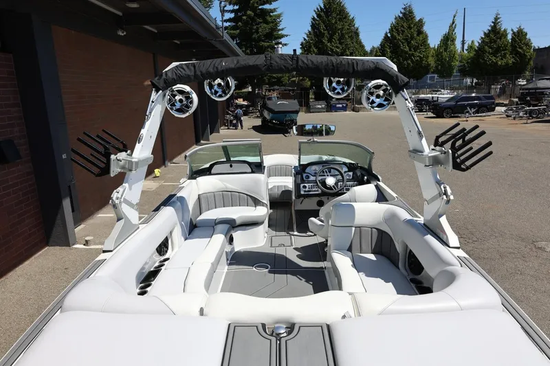 Slide: The Image of 2018 MB B52 23 boat interior with white seating and advanced audio system. - 14