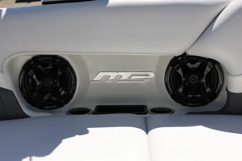 Slide: The Image of MB B52 23 boat interior with speakers, 2018 model, featuring sleek white upholstery. - 24