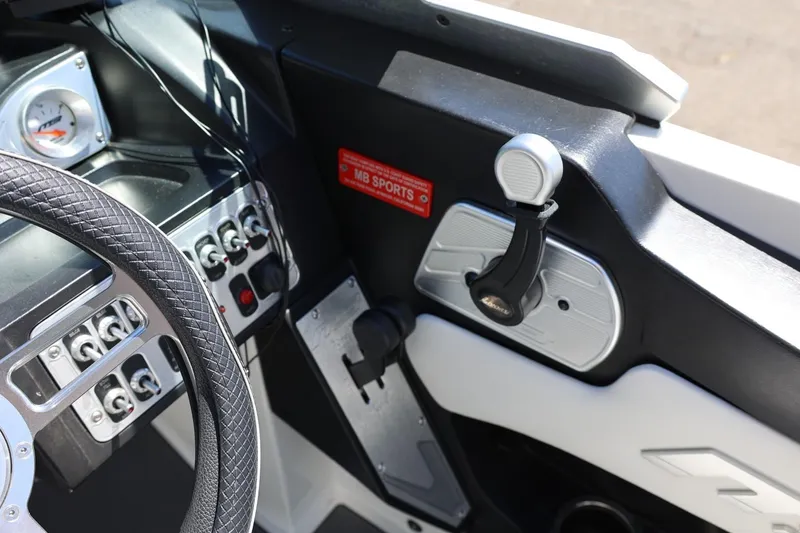 Slide: The Image of Interior of a 2018 MB B52 23 boat showing steering wheel and control panel. - 30
