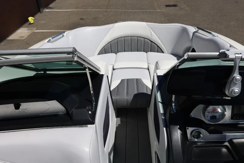 Slide: The Image of Interior view of a 2018 MB B52 23 boat, featuring sleek seating and dashboard. - 33