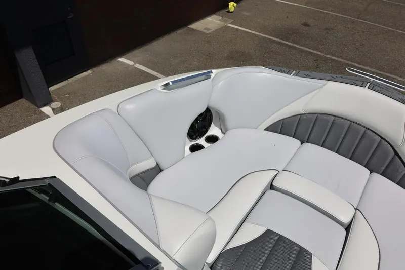 Slide: The Image of 2018 MB B52 23 boat interior with white and gray cushioned seating. - 36