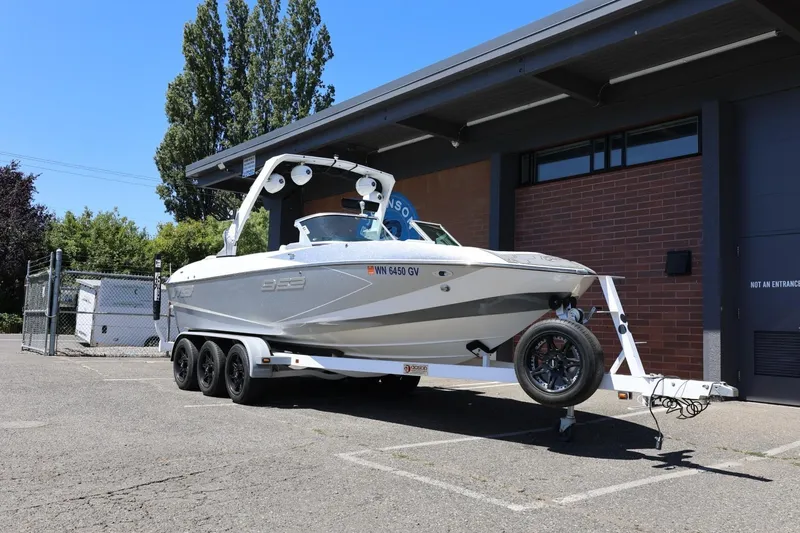 Slide: The Image of 2018 MB B52 23 boat on trailer parked outside a building. - 4