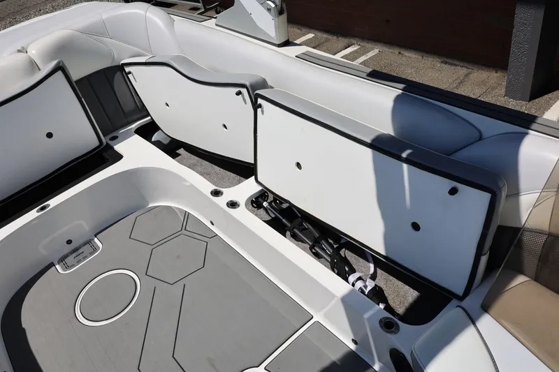Slide: The Image of 2018 MB B52 23 boat interior with open storage compartments and gray flooring. - 40