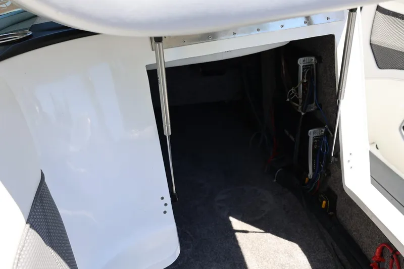 Slide: The Image of Interior view of 2018 MB B52 23 boat showing storage compartment and wiring. - 46