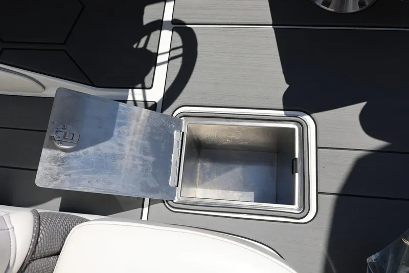 Slide: The Image of Open storage compartment on MB B52 23 boat, 2018 model, with gray flooring. - 47