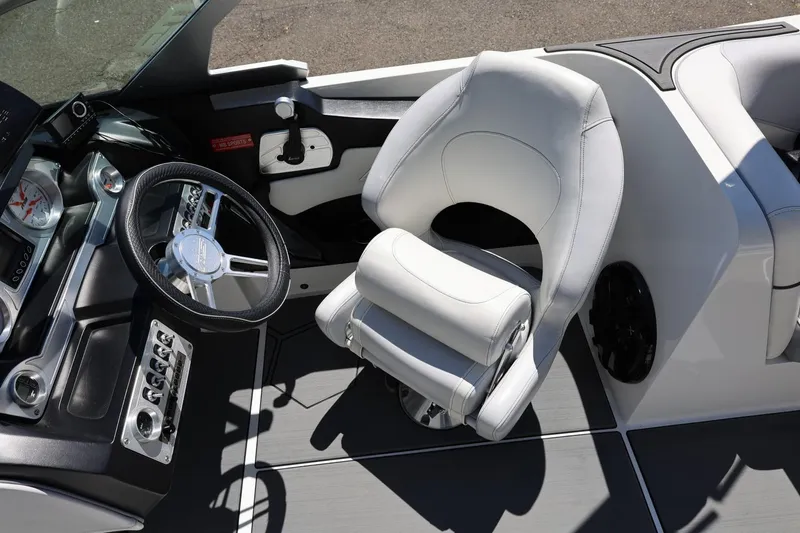 Slide: The Image of Interior of 2018 MB B52 23 boat with steering wheel and white captain's chair. - 48