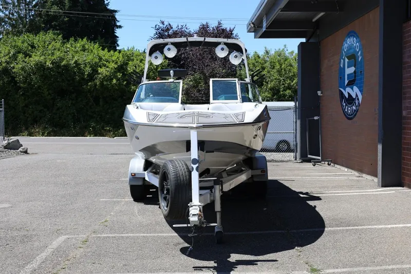 Slide: The Image of 2018 MB B52 23 boat on trailer in parking lot near marina. - 5
