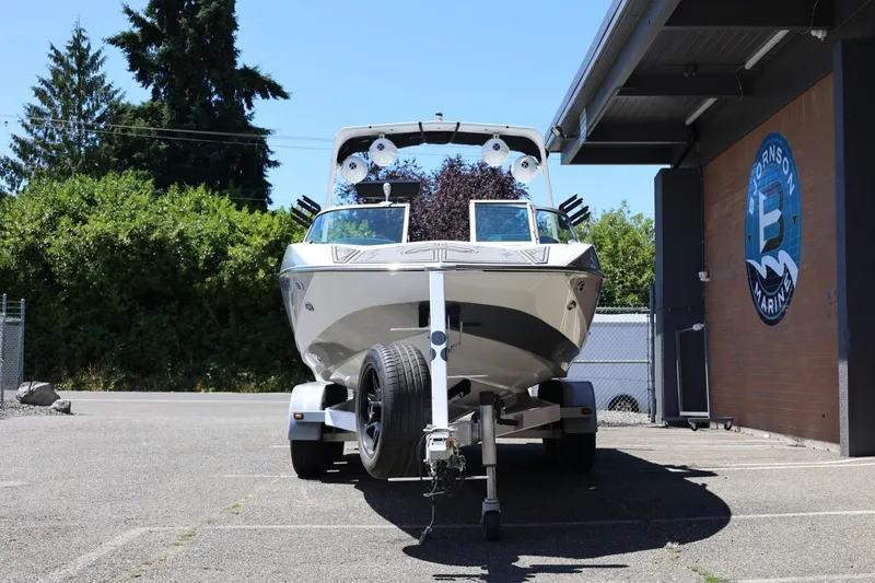 Slide: The Image of 2018 MB B52 23 boat on trailer outside a marine shop. - 6