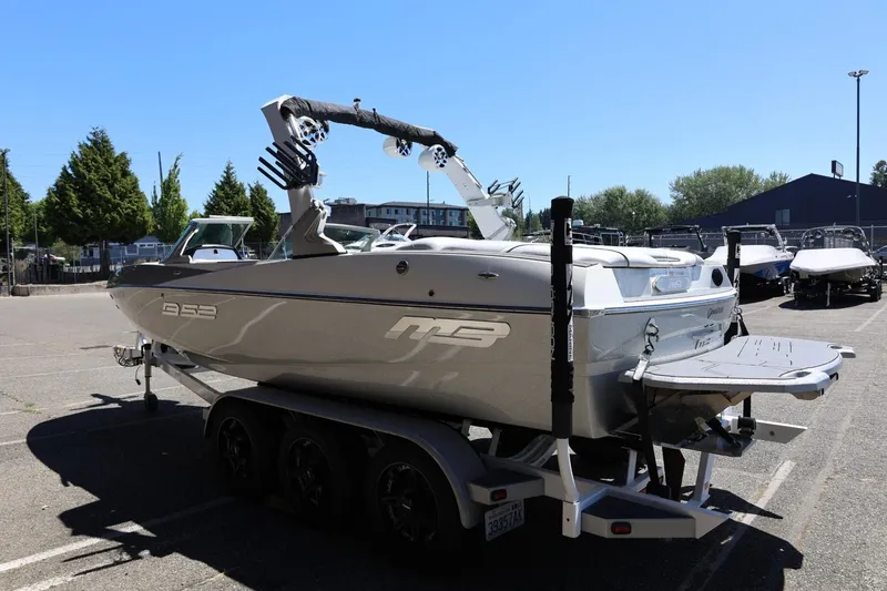 Slide: The Image of 2018 MB B52 23 boat on trailer in parking lot, sunny day. - 9