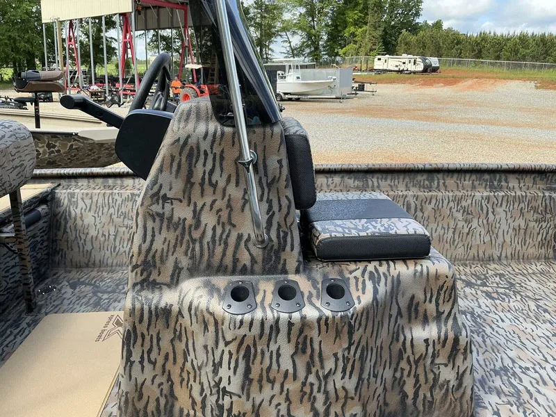 Slide: The Image of 2026 Xpress Xplorer Series XP20CC boat interior with camouflage design and seating. - 3