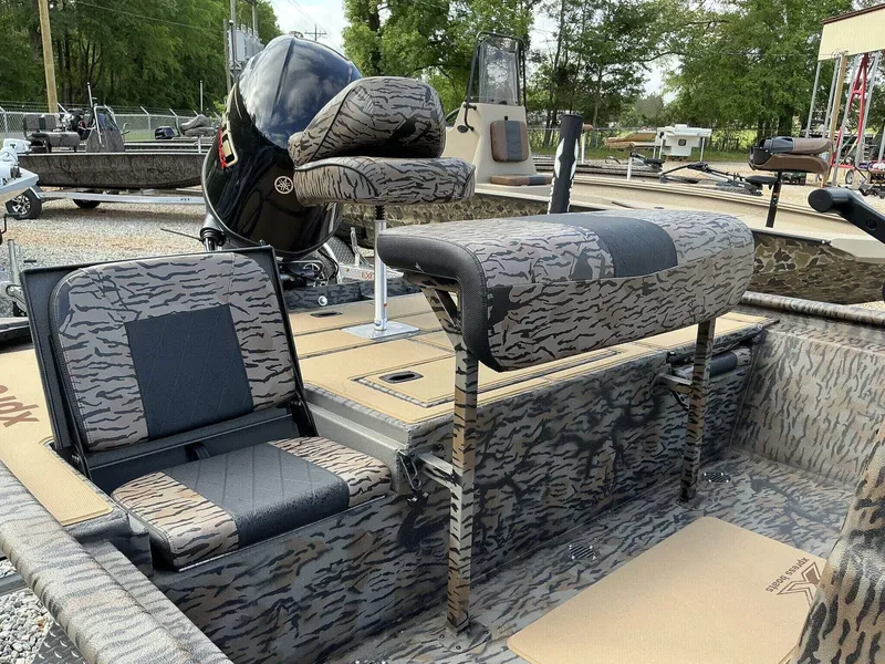 Slide: The Image of 2026 Xpress Xplorer Series XP20CC boat with camo seating and powerful outboard motor. - 4