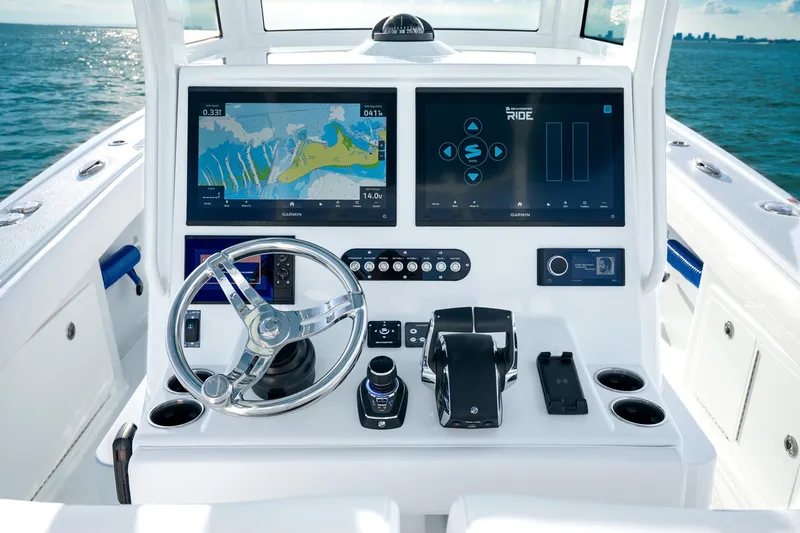 Slide: The Image of 2026 Yellowfin 36 Offshore boat dashboard with advanced navigation screens and controls. - 13