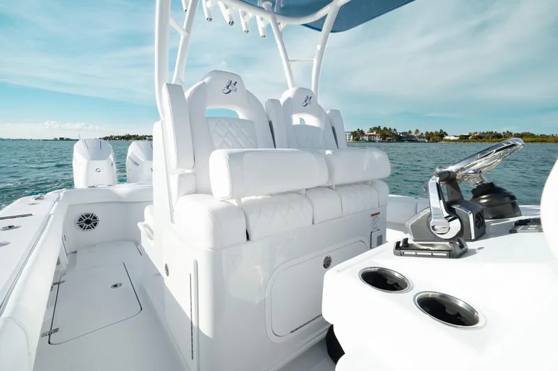 Slide: The Image of 2026 Yellowfin 36 Offshore boat interior with white seating and ocean view. - 14