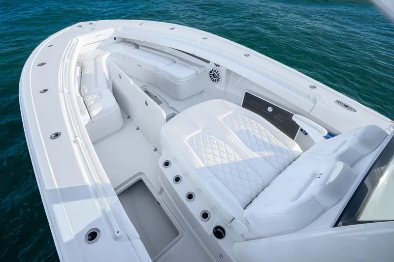 Slide: The Image of 2026 Yellowfin 36 Offshore boat interior with luxurious white seating on blue water. - 17