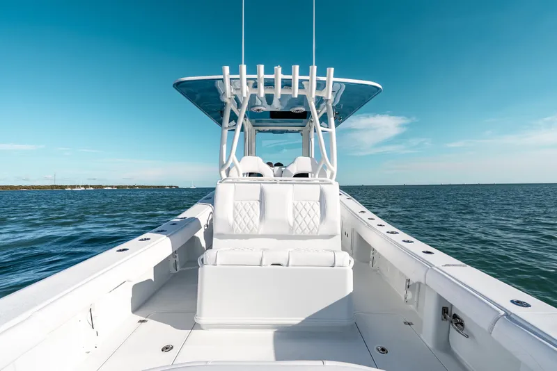 Slide: The Image of 2026 Yellowfin 36 Offshore boat on open water under clear blue sky. - 24
