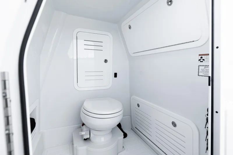Slide: The Image of 2026 Yellowfin 36 Offshore boat interior with modern white marine toilet and storage compartments. - 38
