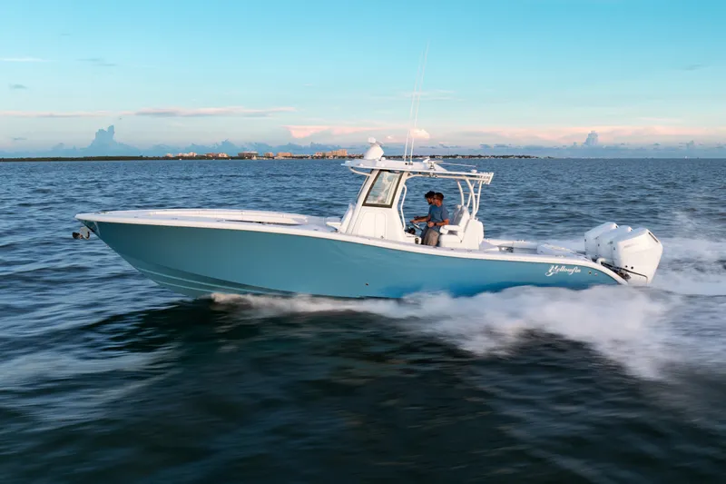 Slide: The Image of 2026 Yellowfin 36 Offshore boat cruising on open water at sunset. - 4