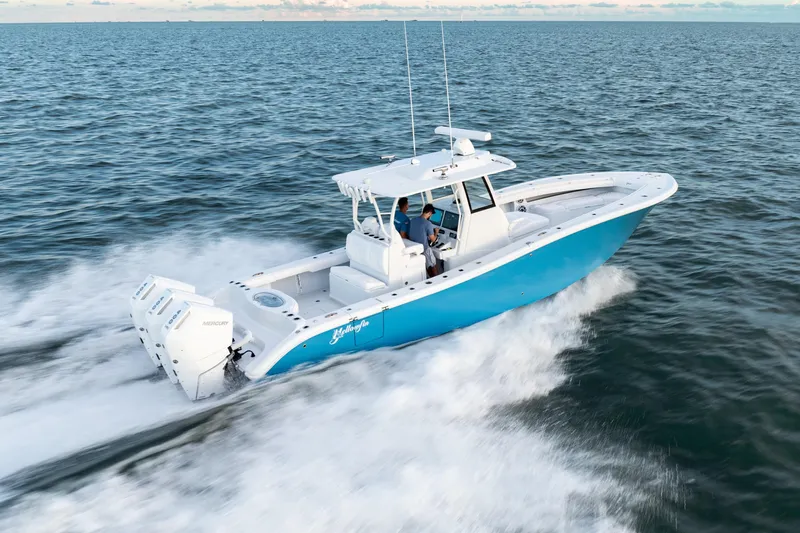 Slide: The Image of 2026 Yellowfin 36 Offshore boat cruising on open water, featuring triple outboard engines. - 5