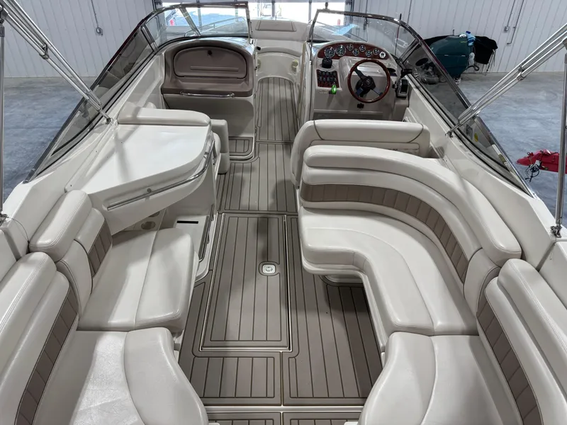 Slide: The Image of Interior of a 2000 Regal 2800 LSR boat with spacious seating and sleek design. - 12