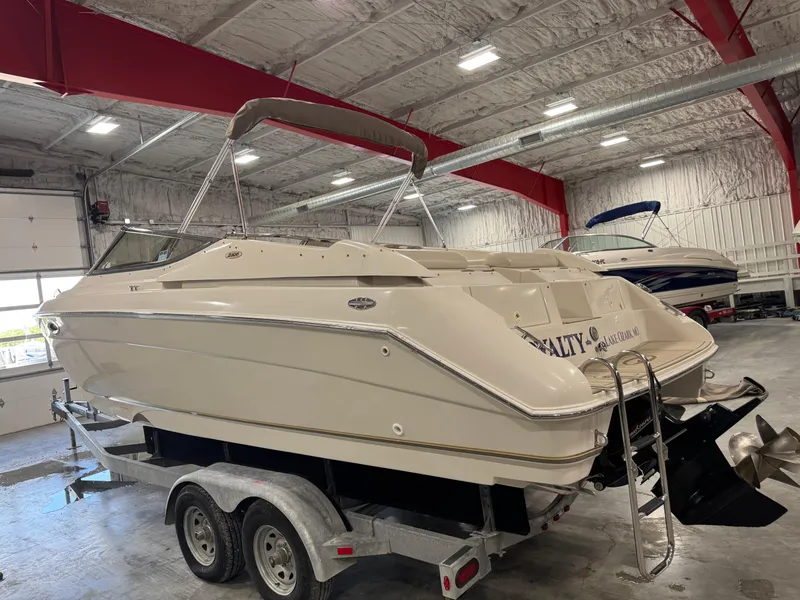 Slide: The Image of 2000 Regal 2800 LSR boat on trailer in indoor storage facility. - 3