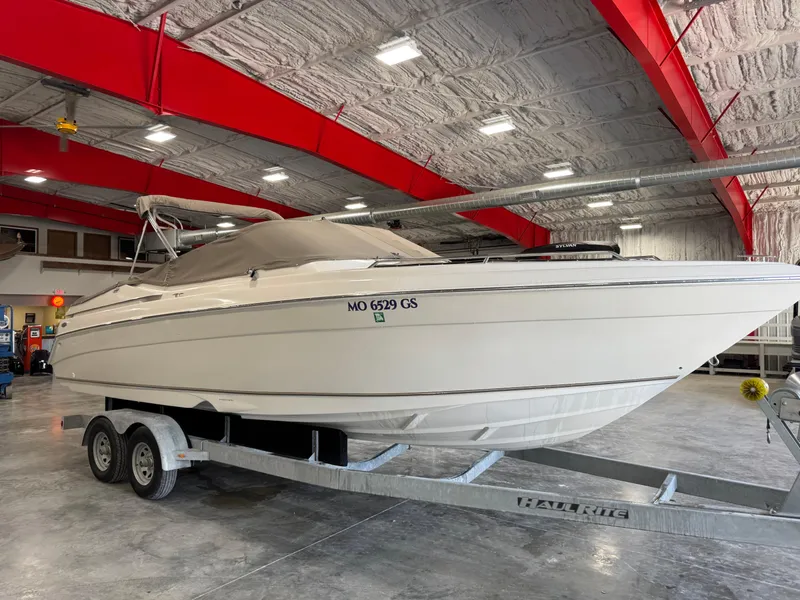 Slide: The Image of 2000 Regal 2800 LSR boat on trailer in indoor storage facility. - 5