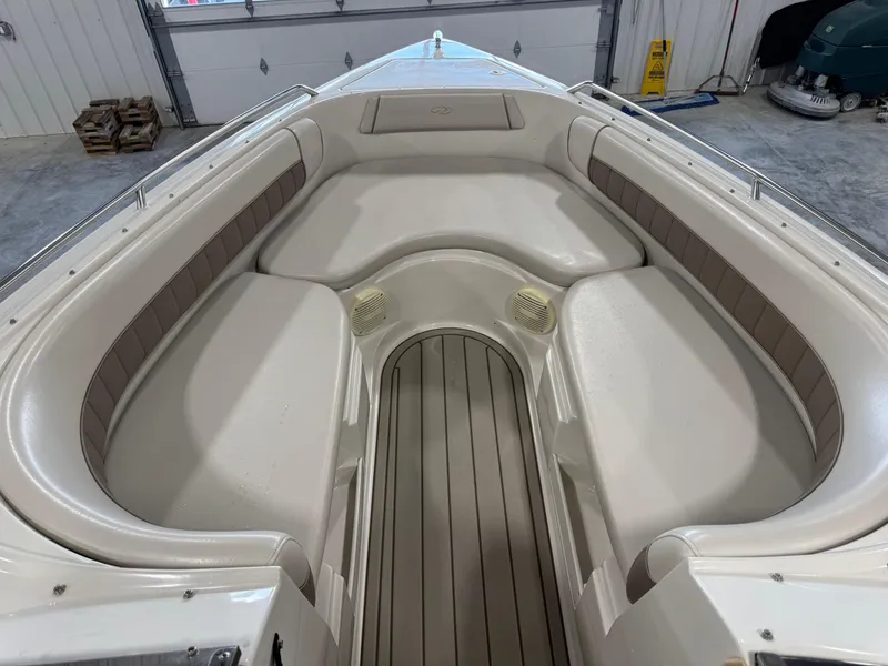 Slide: The Image of Interior of a 2000 Regal 2800 LSR boat with beige seating and wood flooring. - 7