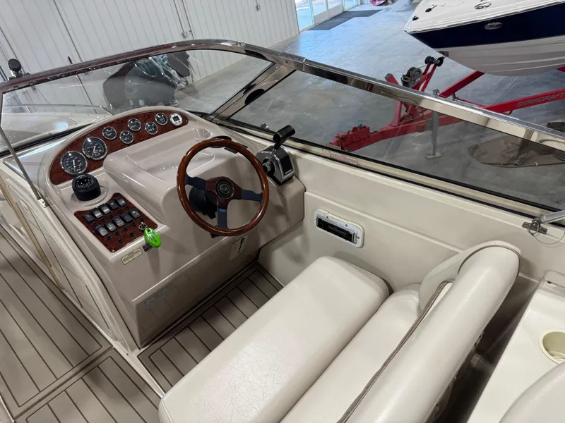 Slide: The Image of Interior view of a 2000 Regal 2800 LSR boat cockpit with steering wheel and controls. - 8