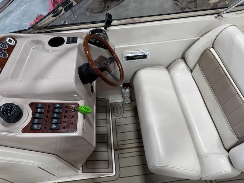 Slide: The Image of Interior of a 2000 Regal 2800 LSR boat with steering wheel and control panel. - 9