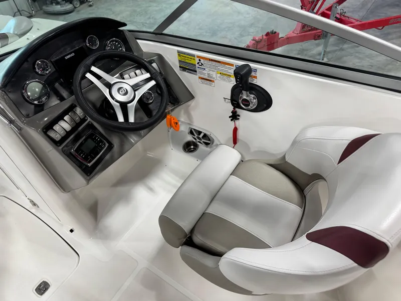 Slide: The Image of 2017 Hurricane SD 2200 DC boat cockpit with steering wheel and captain's chair. - 7