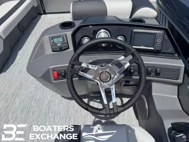 Slide: The Image of Steering wheel and dashboard of a 2026 Bennington 22SSRSE boat. - 9