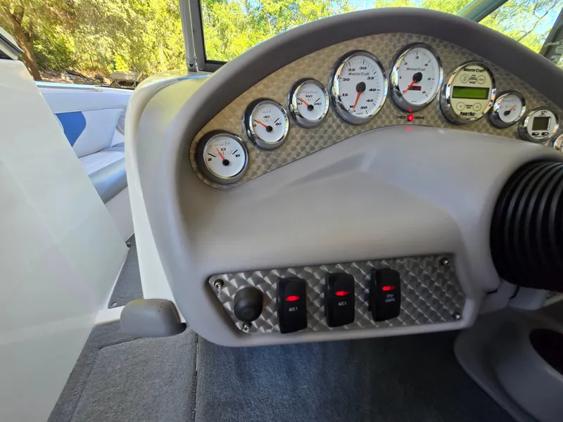 Slide: The Image of 2002 MasterCraft XStar dashboard with gauges and control switches, interior view. - 10