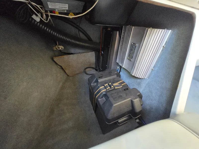Slide: The Image of 2002 MasterCraft XStar interior showing battery and amplifier setup. - 12