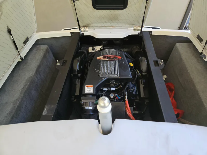 Slide: The Image of 2002 MasterCraft XStar engine compartment with open hatch, showcasing the inboard motor. - 14