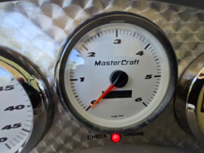 Slide: The Image of Close-up of 2002 MasterCraft XStar tachometer with check engine light on. - 4