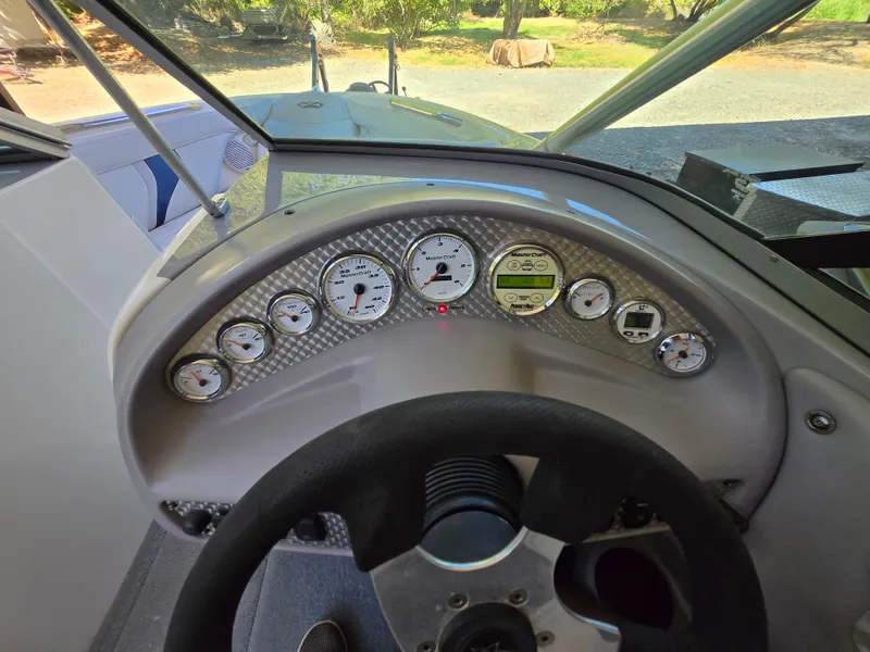 Slide: The Image of Dashboard of a 2002 MasterCraft XStar boat with gauges and steering wheel. - 5