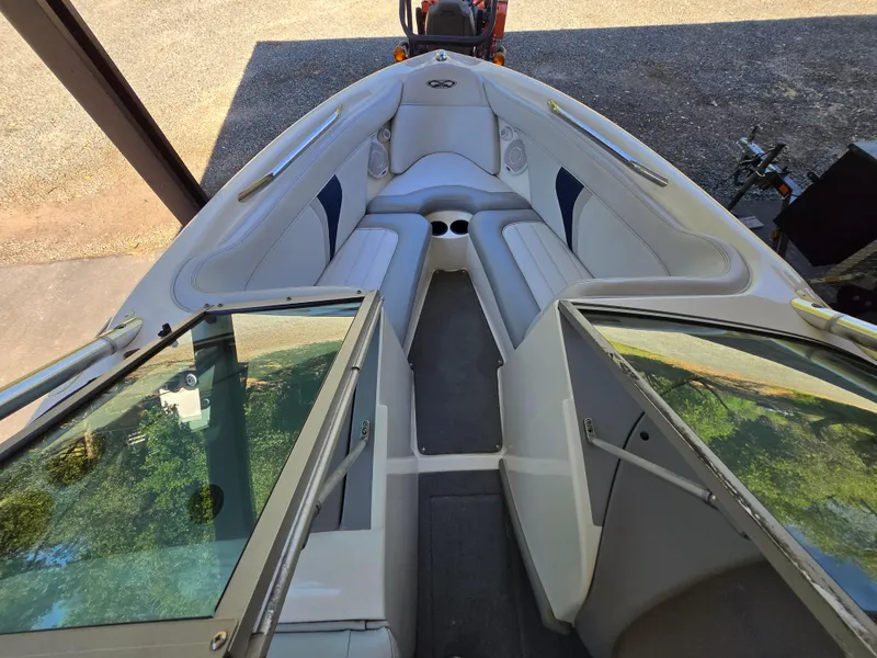 Slide: The Image of 2002 MasterCraft XStar boat interior with white seating and open windshield. - 7