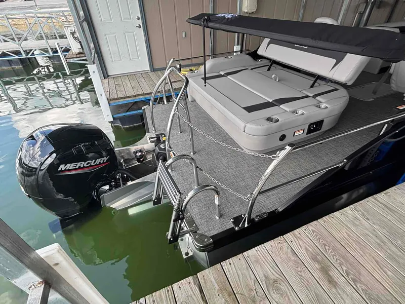 Slide: The Image of 2026 Barletta ARIA A22UC with outboard motor in showroom. - 9