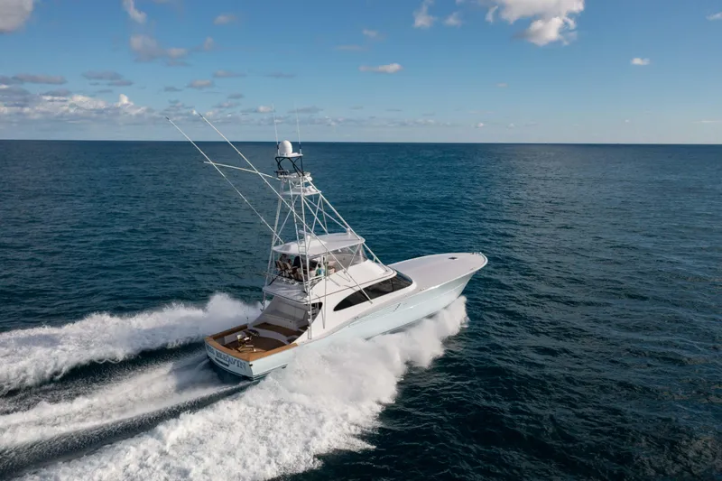 Slide: The Image of 2025 Garlington 71' Flybridge yacht cruising on open ocean under clear skies. - 2