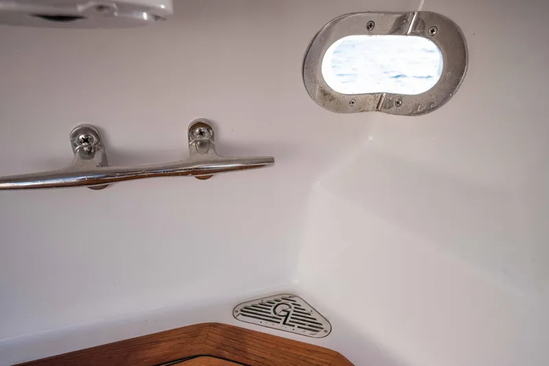 Slide: The Image of Interior of 2025 Garlington 71' Flybridge with porthole and chrome fittings. - 21