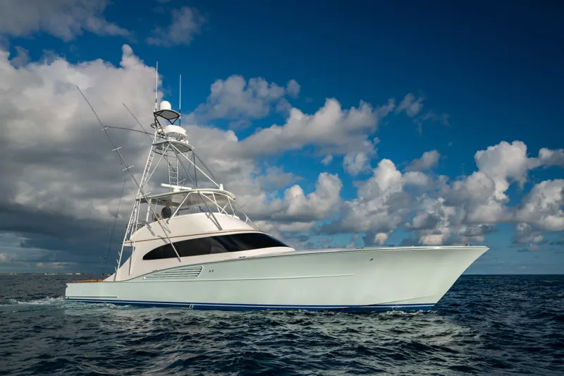 Slide: The Image of 2025 Garlington 71' Flybridge yacht cruising on open sea under cloudy sky. - 23