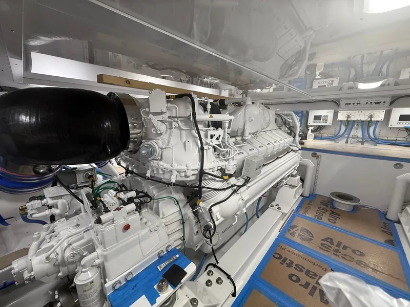 Slide: The Image of Engine room of 2025 Garlington 71' Flybridge yacht, showcasing advanced machinery and systems. - 25