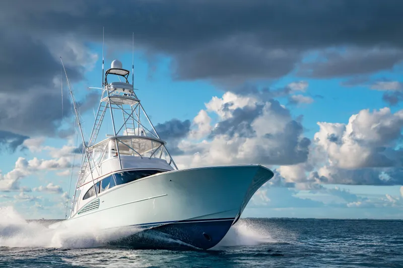 Slide: The Image of 2025 Garlington 71' Flybridge yacht cruising on open water under dramatic clouds. - 7