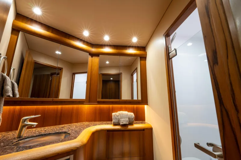 Slide: The Image of Luxurious bathroom interior of 2025 Garlington 71' Flybridge yacht with wood accents and modern fixtures. - 16