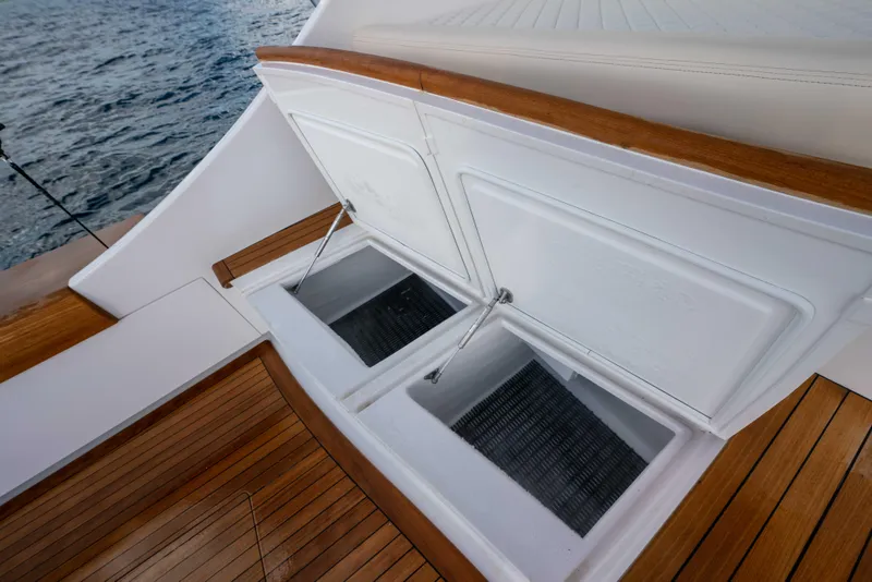 Slide: The Image of Open storage compartments on 2025 Garlington 71' Flybridge yacht with wooden deck. - 20