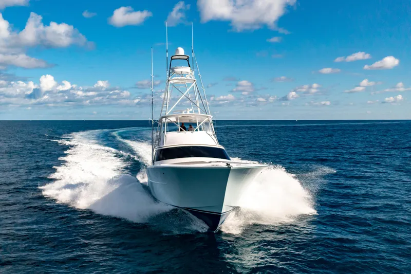 Slide: The Image of Garlington 71' Flybridge 2025 yacht cruising on open ocean under blue sky. - 24