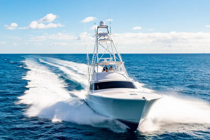 Slide: The Image of 2025 Garlington 71' Flybridge yacht cruising on open ocean under clear sky. - 5