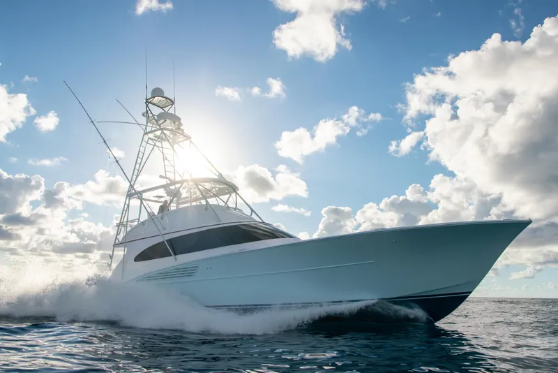 Slide: The Image of 2025 Garlington 71' Flybridge yacht cruising on open water under a bright sky. - 8
