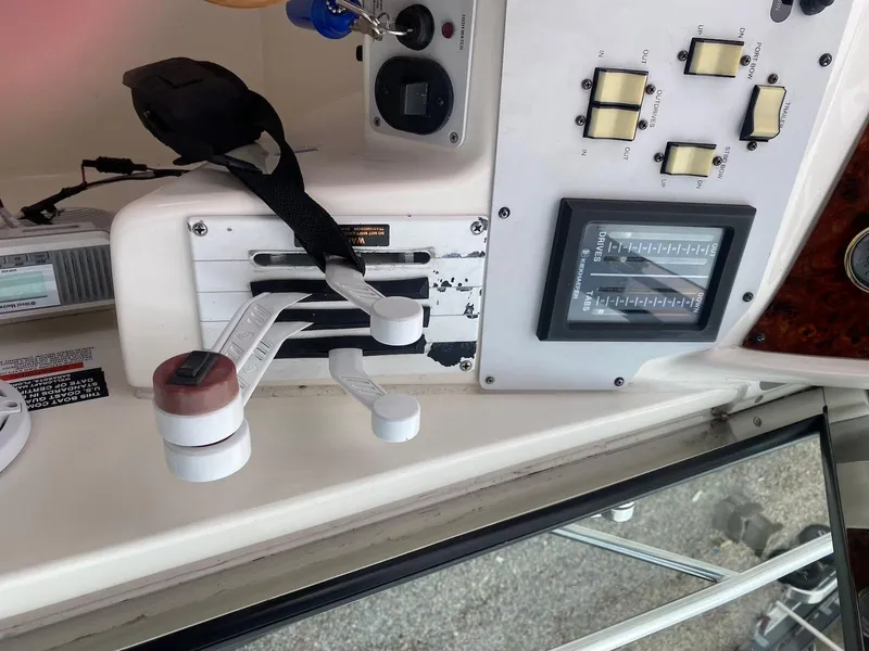 Slide: The Image of Control panel of a 2001 Wellcraft 45 Excalibur boat with levers and switches. - 11