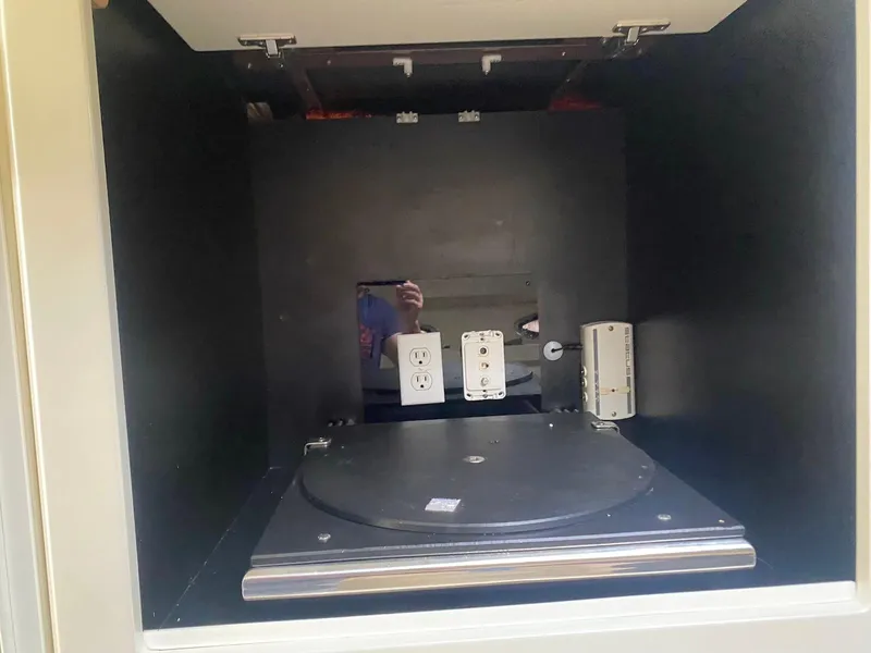 Slide: The Image of Empty cabinet interior with electrical outlets and a rotating platform. - 20