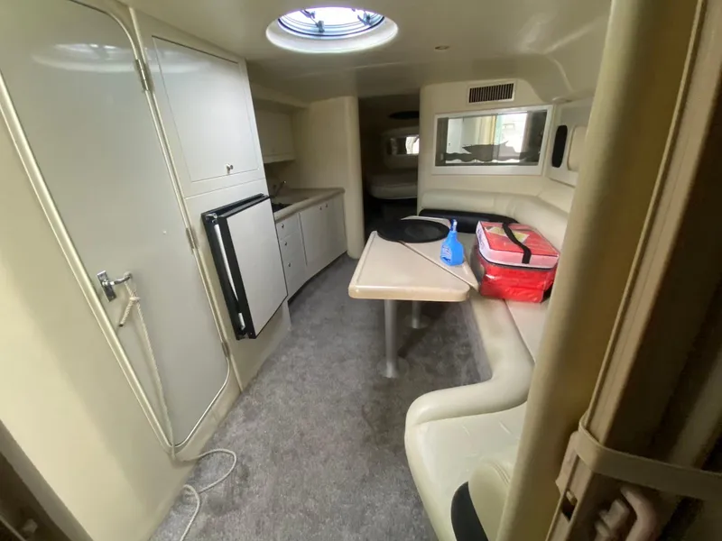 Slide: The Image of Interior of 2001 Wellcraft 45 Excalibur boat with seating, table, and kitchenette. - 24